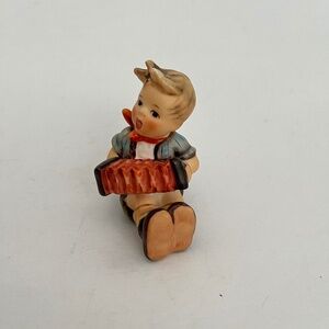 GOEBEL (HUMMEL)  SEATED BOY WITH ACCORDION FIGURINE